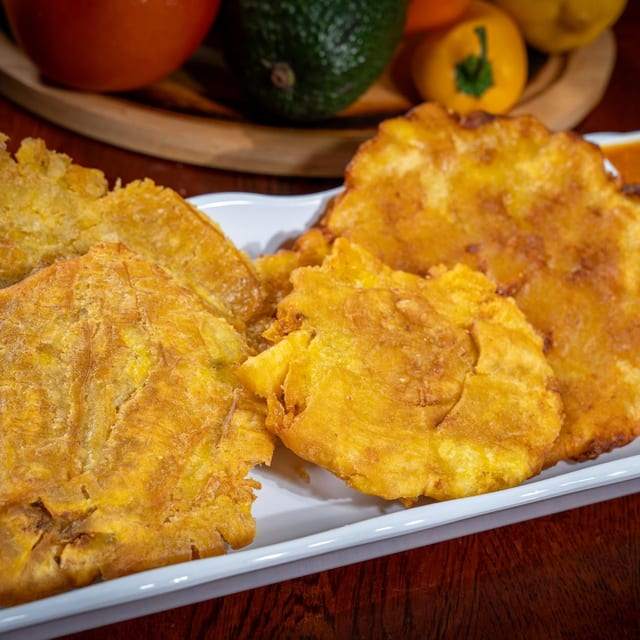 Fried Green Plantains with Guacamole and Hogao (Tostones con Guacamole y Hogao).